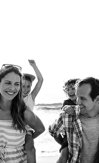 Smaller version of image showing happy family enjoying their time at the seaside